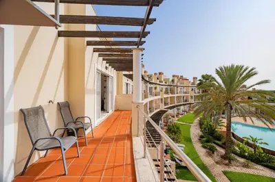 a balcony of a hotel with chairs and a swimming pool at Palmyra Apartments in Vilamoura in Vilamoura