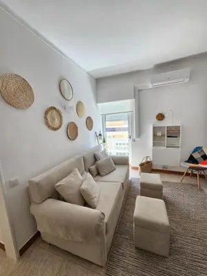 a living room with a couch and a table at Faro Heart House in Faro