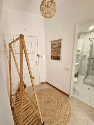 a bathroom with a towel ladder and a shower at Faro Heart House in Faro