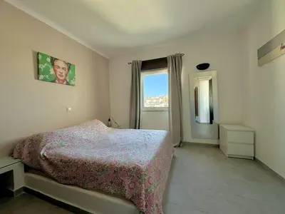 a bedroom with a large bed and a window at Villa Terraza - Center Hideaway in Albufeira