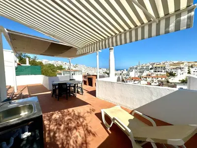 a patio with a table and chairs on a roof at Villa Terraza - Center Hideaway in Albufeira
