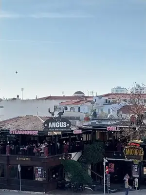 a group of shops on a city street at Albufeira Oura Apartment in Albufeira