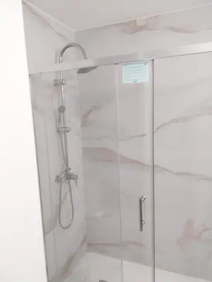 a shower with a glass door in a bathroom at Albufeira Oura Apartment in Albufeira