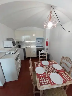 a kitchen with a table and chairs in a room at Albufeira Oura Apartment in Albufeira