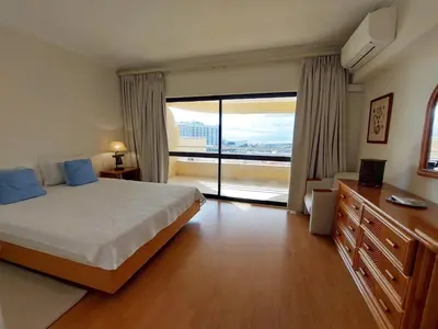 a hotel room with a bed and a large window at Marina Mar Sunset by SAPvillas in Vilamoura