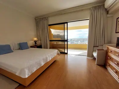 a bedroom with a bed and a large window at Marina Mar Sunset by SAPvillas in Vilamoura