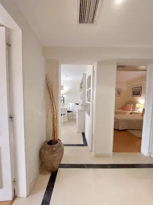a hallway in a house with a vase on the floor at Marina Mar Sunset by SAPvillas in Vilamoura