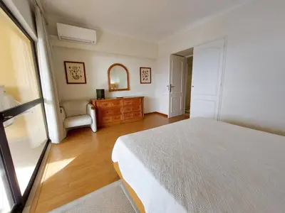 a bedroom with a bed and a dresser and a chair at Marina Mar Sunset by SAPvillas in Vilamoura