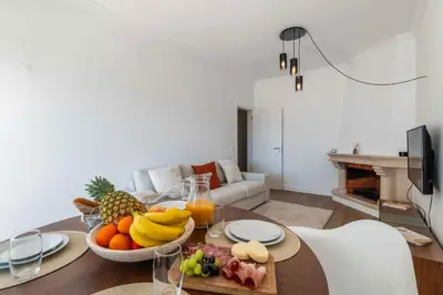 a living room with a table with a bowl of fruit at São Rafael 1 Bedroom with Pool in Albufeira