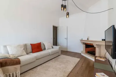 a living room with a couch and a fireplace at São Rafael 1 Bedroom with Pool in Albufeira