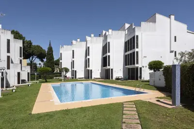 a building with a swimming pool in front of a building at Fonte Moura - With pool by HD in Vilamoura