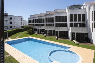 an empty swimming pool in front of a building at Fonte Moura - With pool by HD in Vilamoura