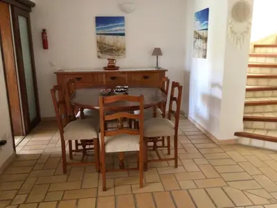 a dining room with a wooden table and chairs at 2 Bedroom Townhouse, Vale de Parra in Guia