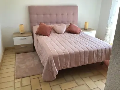 a bedroom with a pink bed with two night stands at 2 Bedroom Townhouse, Vale de Parra in Guia