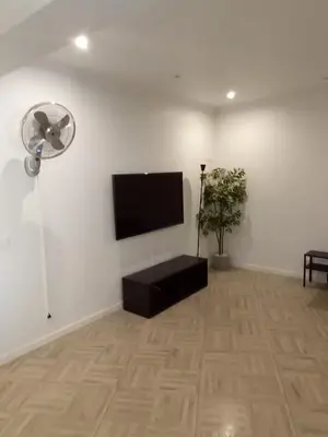 a living room with a flat screen tv and a fan at Panoramic View in Albufeira