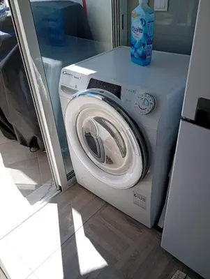 a washing machine with a bottle of detergent on top of it at Panoramic View in Albufeira