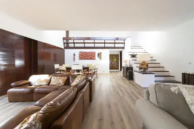 a living room with a couch and a dining room at Casa da Colina in Albufeira