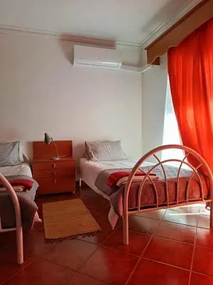 a bedroom with two beds and a window at Villa Vacations Marie in Albufeira