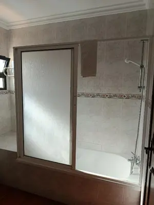 a shower with a glass door in a bathroom at Villa Vacations Marie in Albufeira