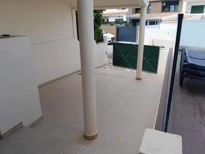a white pole on a balcony with a bench at Villa Vacations Marie in Albufeira