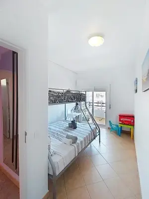 a living room with a blue couch and a table at Central View 990 meters from beach on foot in Albufeira