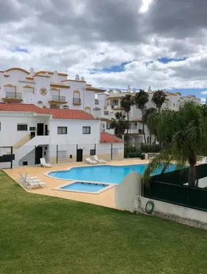 a large swimming pool in front of a building at Central View 990 meters from beach on foot in Albufeira
