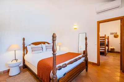 a bedroom with a bed in a room at Quinta da Bisa - Casa das Pedrinhas in Algoz