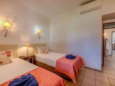 a hotel room with two beds and a mirror at Villa Rosa by Interhome in Sesmarias