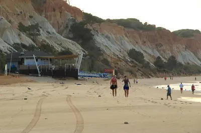 a group of people walking on the beach at Modern Apartment in Albufeira in Albufeira