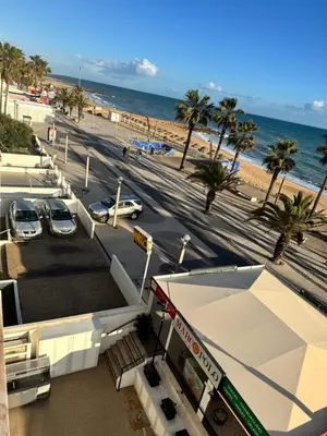 a view of a gas station next to the beach at Adrimar - Beachfront Sea View 2BR Apartment in a prime location in Quarteira