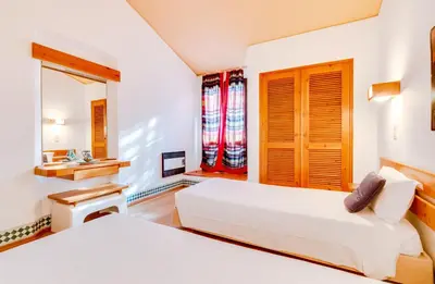 a bedroom with two beds and a sink and a mirror at Volta da Vinha, 3bdr Private Vila in Vilamoura in Vilamoura