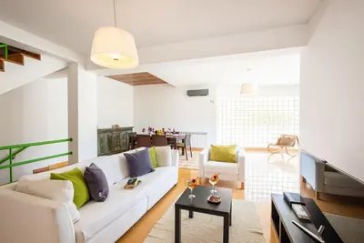 a living room with a white couch and a table at Villa Marina by Algarve Vacation in Albufeira