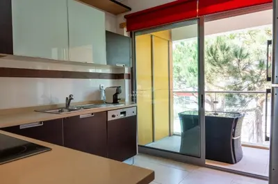 a kitchen with a sink and a large window at Apartamento Varandas do Mar in Albufeira