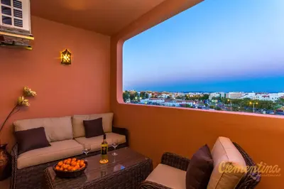 a room with a couch and a table and a window at Clementina Apartment in Albufeira