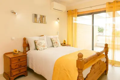 a bedroom with a large bed and a window at Spacious Villa by Algarve Dream Holidays in Albufeira