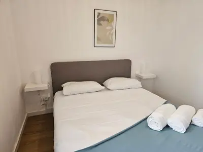 a bed with white sheets and pillows in a room at Blife Luya private rooms in Faro