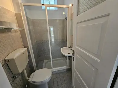 a bathroom with a shower and a toilet and a sink at Blife Luya private rooms in Faro