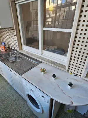 a kitchen with a washing machine and a sink at Blife Luya private rooms in Faro