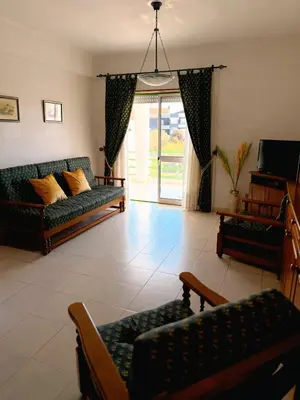 a living room with two couches and a tv at Jardim Santa Eulália By Albufeira Rental in Albufeira