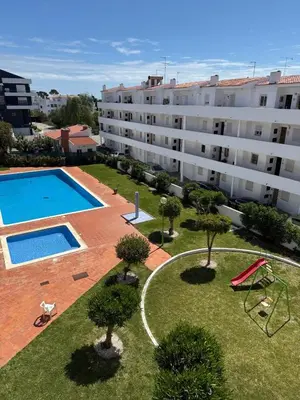 an apartment with a swimming pool and a building at Jardim Santa Eulália By Albufeira Rental in Albufeira
