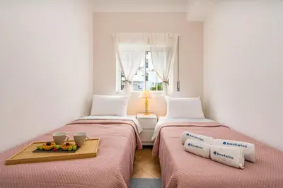 two beds in a room with fruit on a tray at Sunny Flat w/ Balcony near the Sea by HostWise in Albufeira