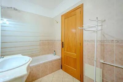 a bathroom with a tub and a sink and a shower at Apartmento Estrela de Albufeira Old Town Beach in Albufeira