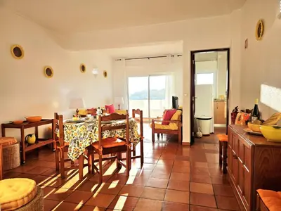 a living room with a yellow couch and a window at Corte Real Apartment O - Sea & Old Town View in Albufeira