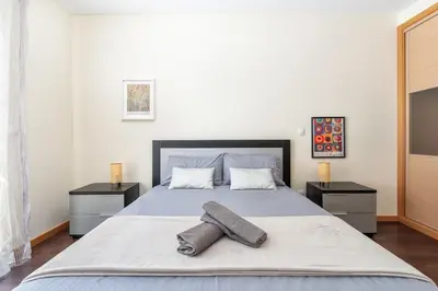 a bedroom with a bed with two pillows on it at Vacances Tranquilles in Olhos de Água