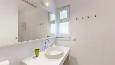 a white bathroom with a sink and a mirror at Apartamento Studio Sao Rafael, 450m Praia in Albufeira