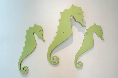 three green seahorse cutouts on a wall at Blife Riamya private rooms in Faro