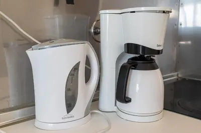 two coffeemakers sitting next to each other on a counter at Blife Riamya private rooms in Faro
