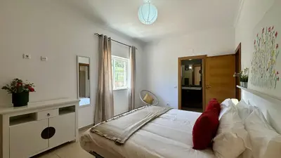 a kitchen with a sink and a table with chairs at Casa do Campo by Check-in Portugal in Tunes