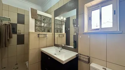 a small bathroom with a bed and a shower at Casa do Campo by Check-in Portugal in Tunes