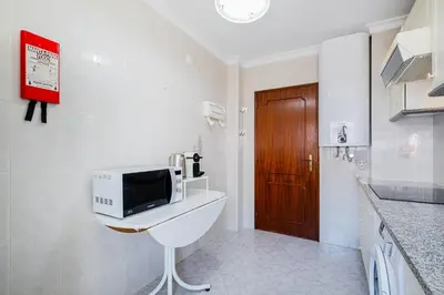 a kitchen with a white refrigerator and a sink at Old Town Soul in Albufeira